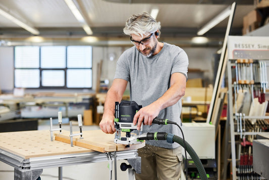Festool OF 1400 EBQ-Plus Oberfräse beim Fräsen von Holz mit Führungsschiene in Werkstatt